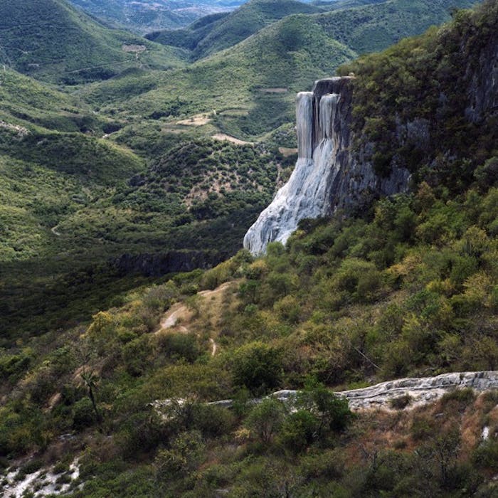 petrified waterfall hierva agua amongst rolling green hills