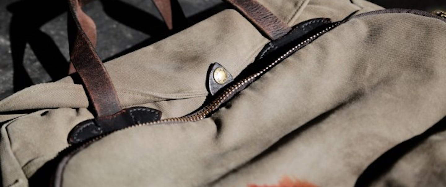 Beige Filson Padded Computer Bag with brown leather straps