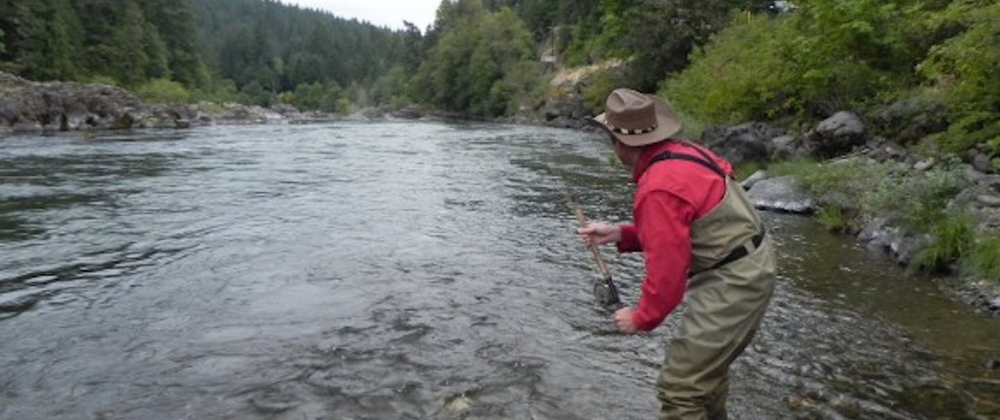 man fly-fishing in river