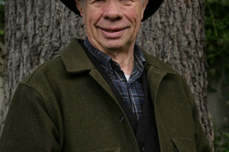 Paul Hanson in green wool jacket, black stetson hat and blue plaid shirt