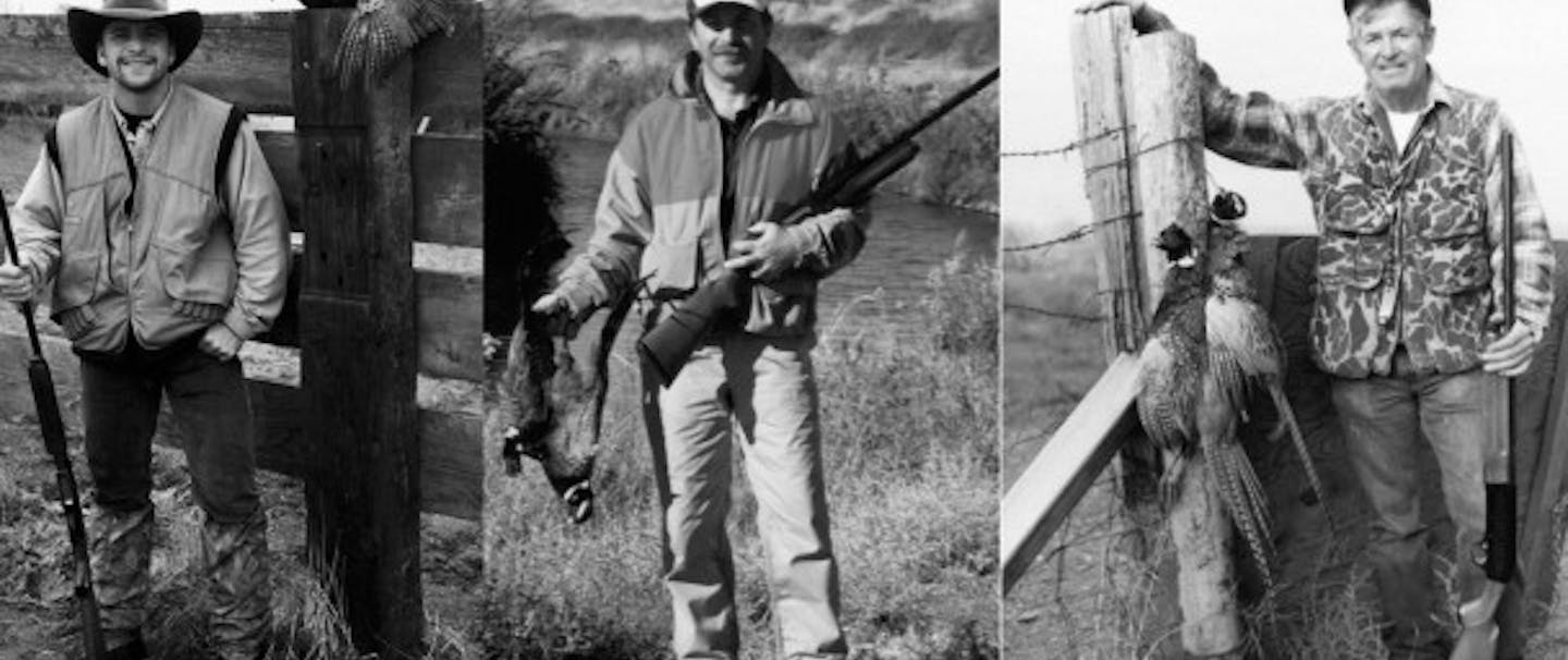 Three generations of hunters stand with their pheasants in filson hunting gear