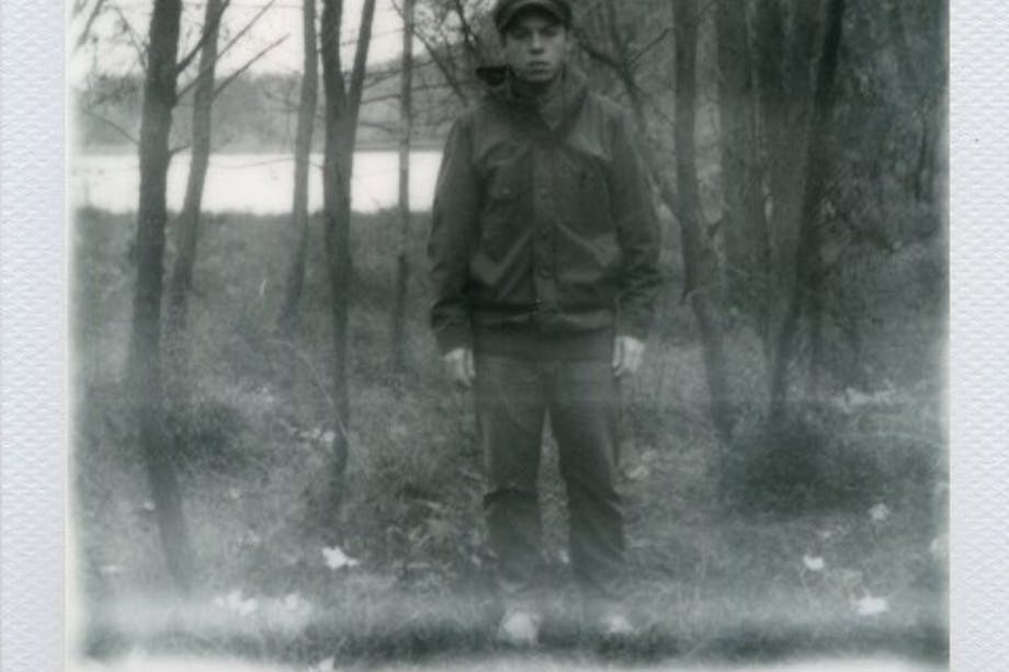 George barnett black and white polaroid of man standing in front of woodland lake