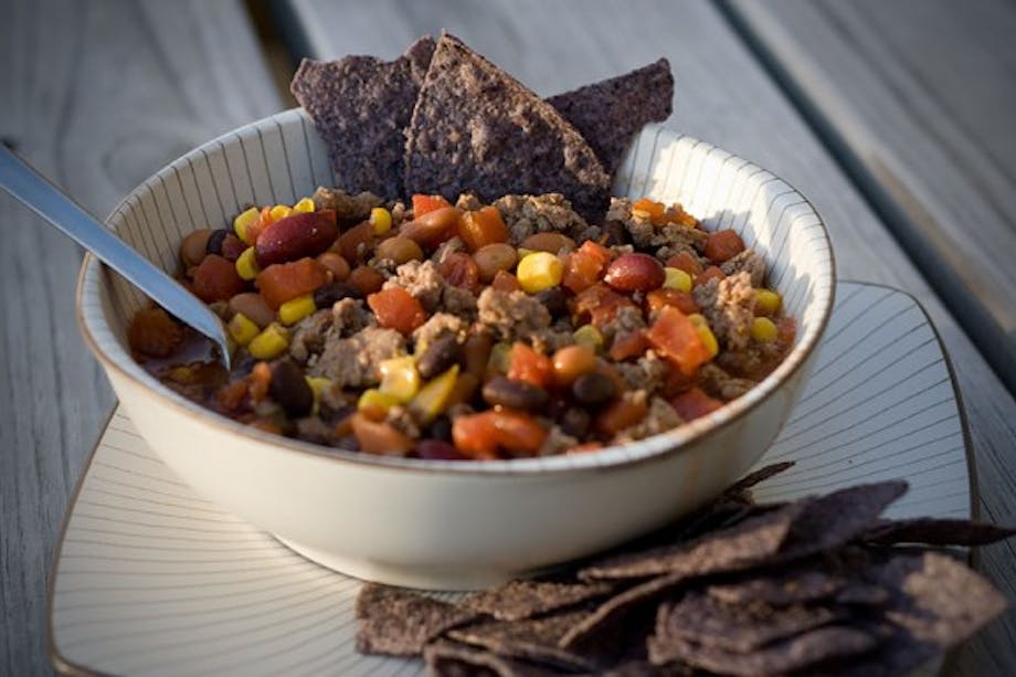 bowl of southwest venison chili and blue corn tortilla chips