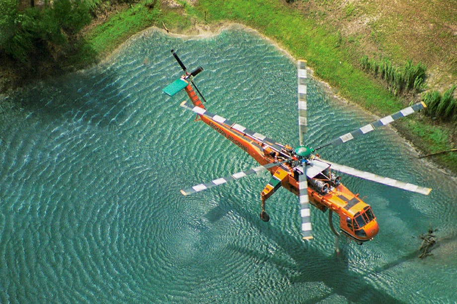 Helicopter flying over pond