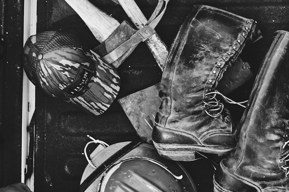 black and white firefighter gear on wood floor
