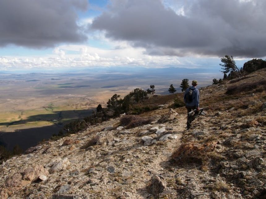 man walking down ridge