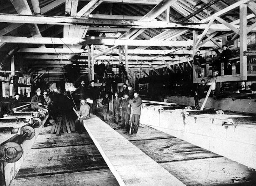 men standing in lumber mill