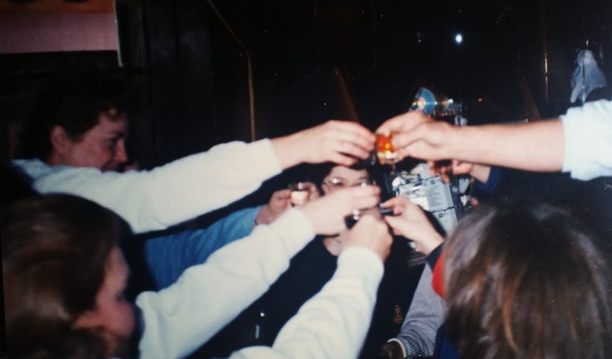 group of friends cheering drinks together