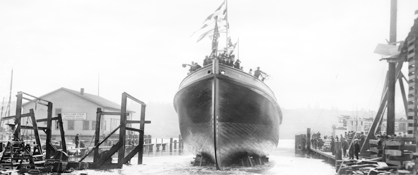 a black and white image of a boat in a boat yard being sent off into the water