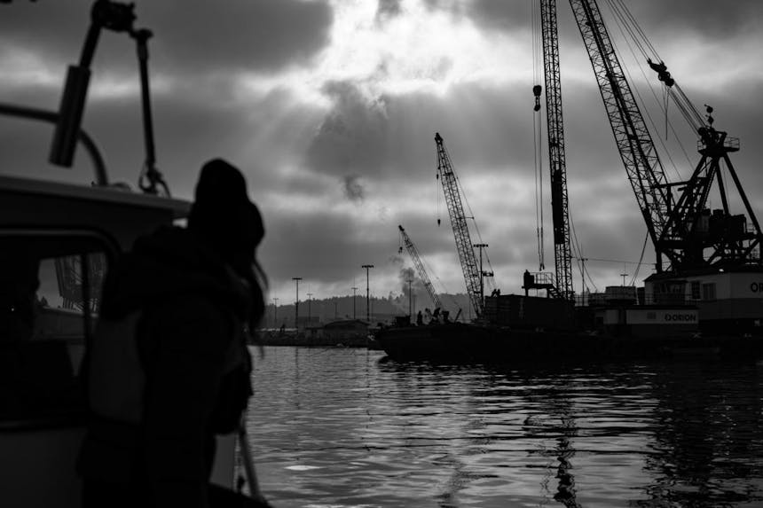 a black and white shot from the hull of the boat looking towards the seattle shipping yard