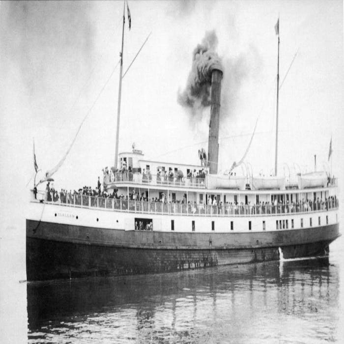 a black and white image of the bow of the SS Clallam with passengers prior to its sinking