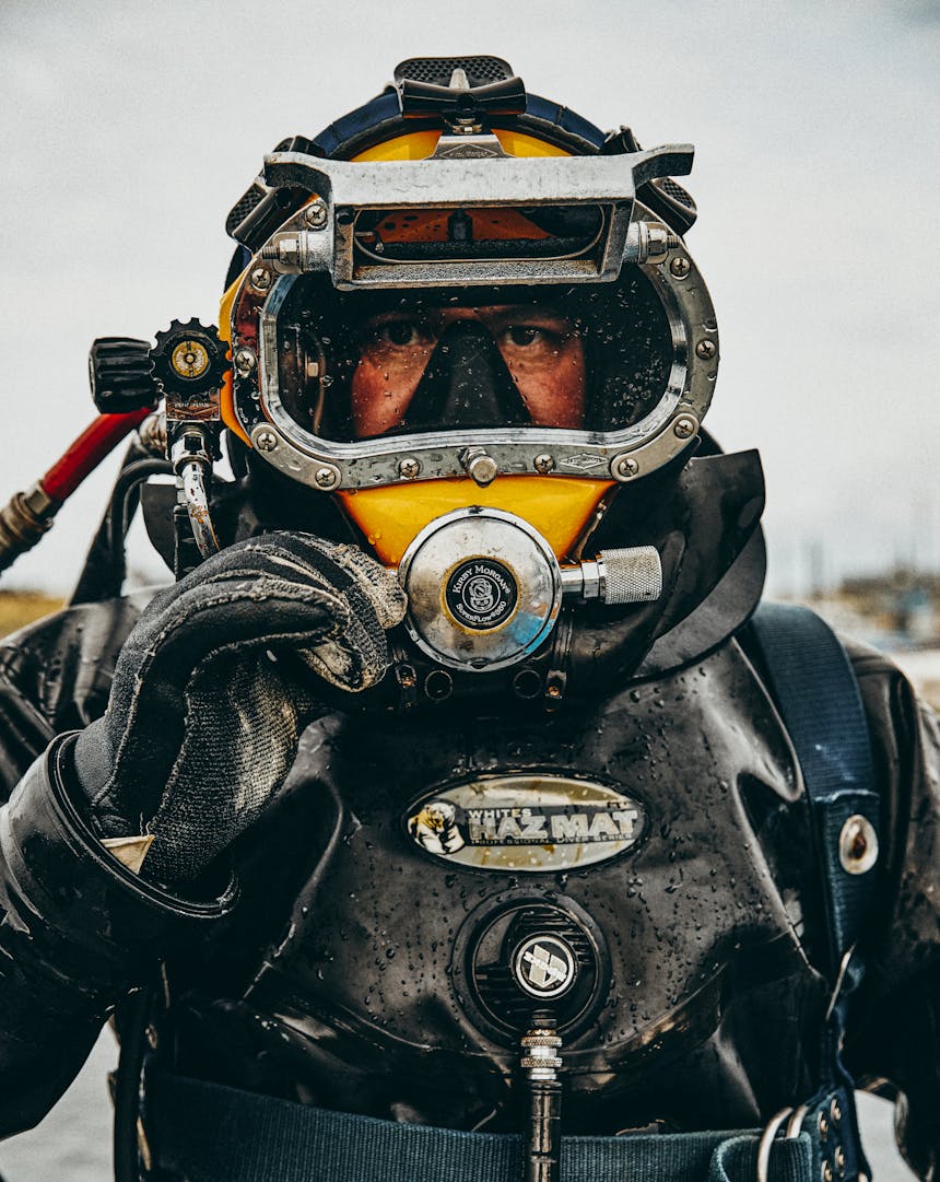 chest up view of person in scuba gear standing above water