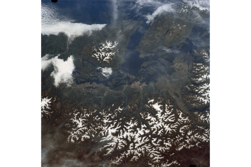 aerial view of snow covered cascade glaciers and the puget sound