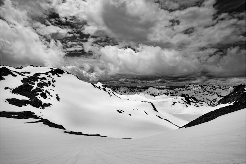 black rocky peaks poking out of snow covered plains stretching away into the horizon