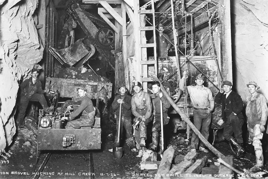 black and white archival image of crew of men working on the great cascade tunnel