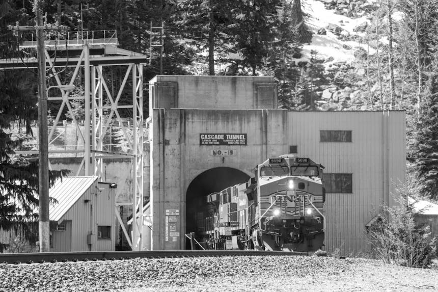 black and white of modern train passing through the cascade tunnel