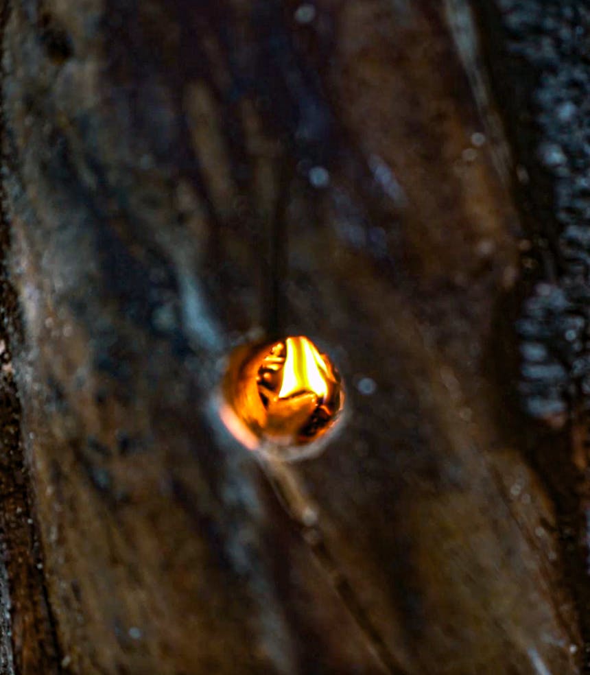closeup image of flames burning in a rocket stove log