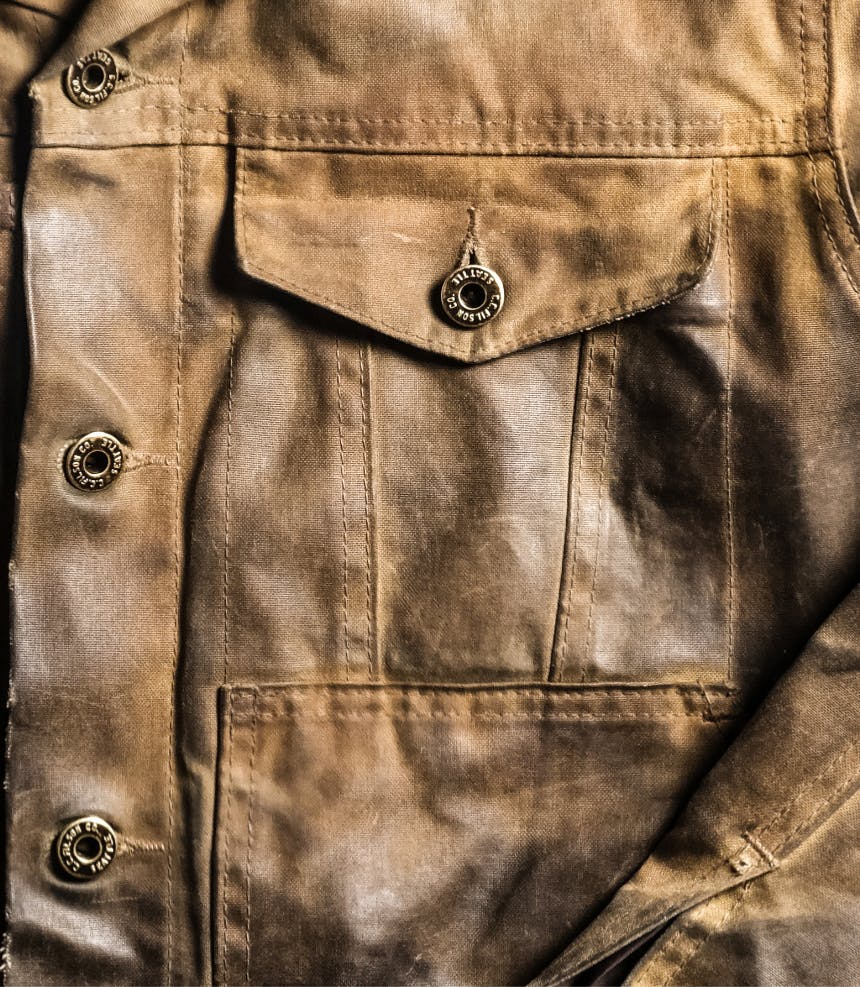 worn waxed cotton coat close-up coat with buttons