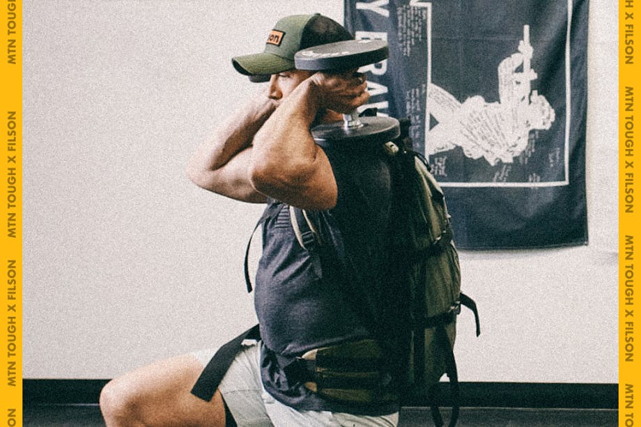 man wearing backpack with dumbbells over shoulders doing lunge squat