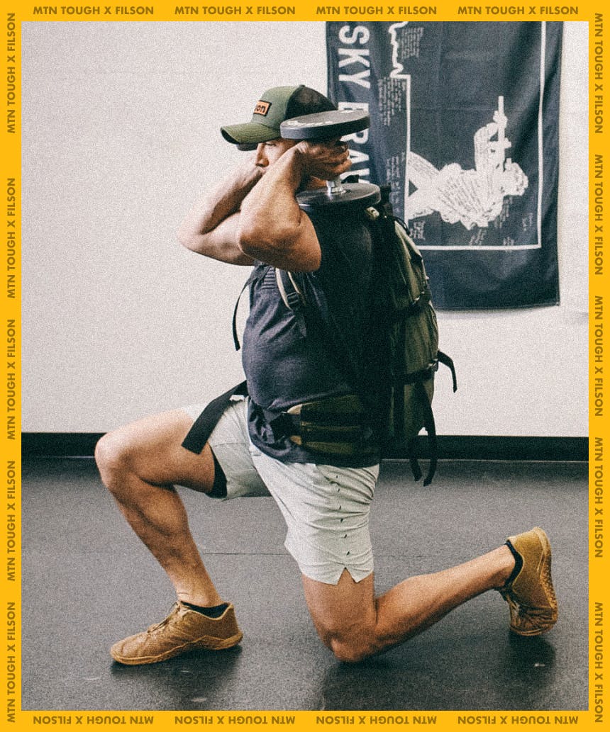 man wearing backpack with dumbbells over shoulders doing lunge squat