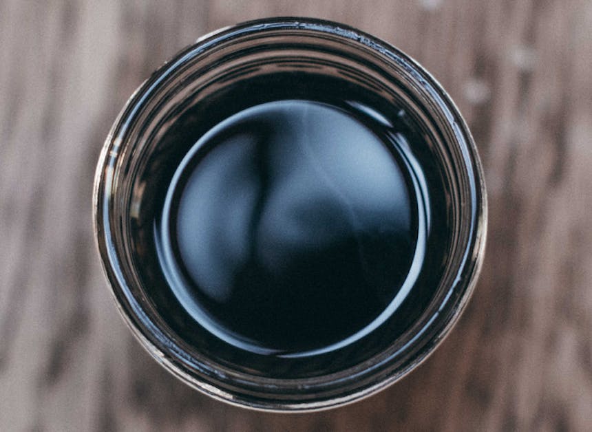 top down view of a jar with dark black liquid in the bottom