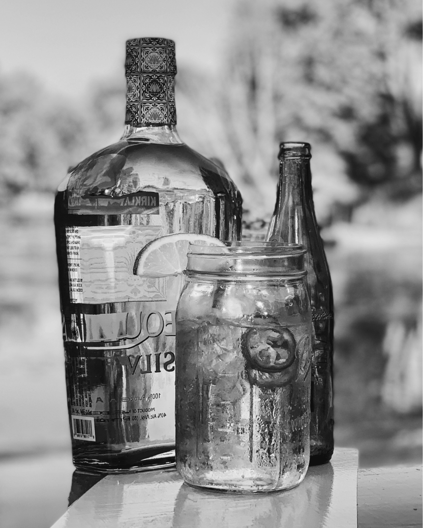 ranch water cocktail in a mason jar in front of two glass bottles