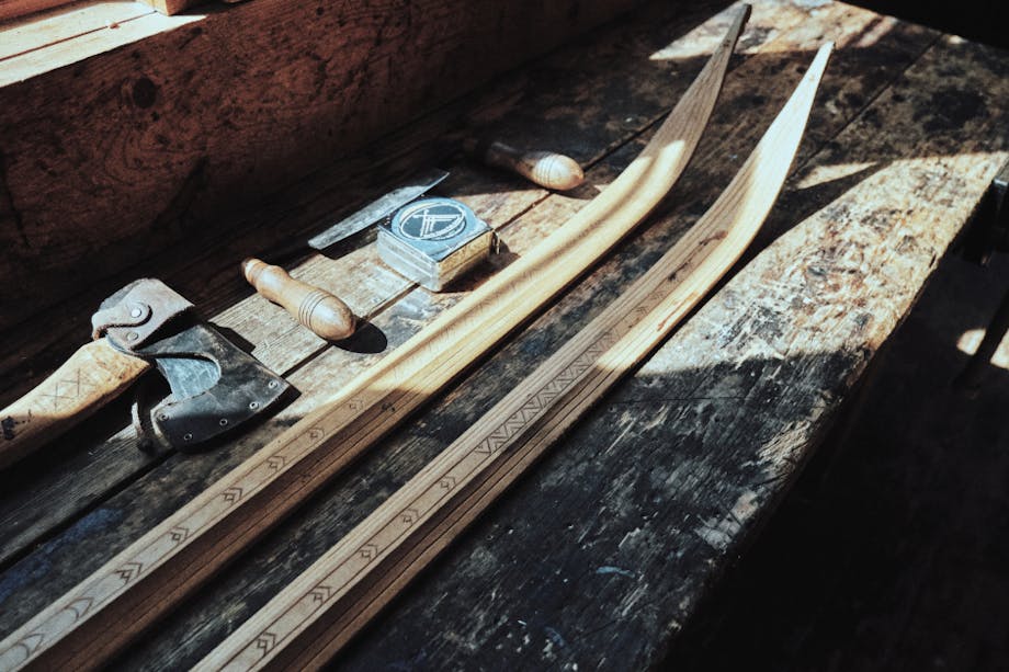 wooden cross country skis being built and honed on a wooden table