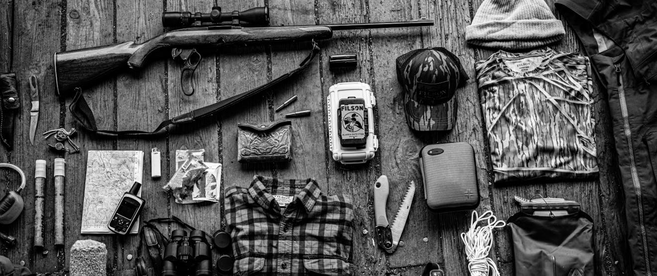 hunting gear layout from above on a wooden floor