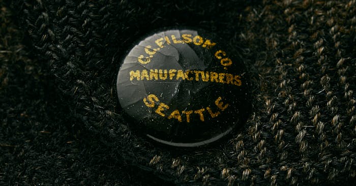 black button with gold lettering on knitted wool 