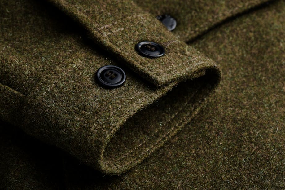 close-up of cuff of mackinaw wool olive colored jacket cuff