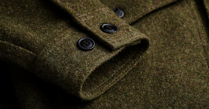close-up of cuff of mackinaw wool olive colored jacket cuff