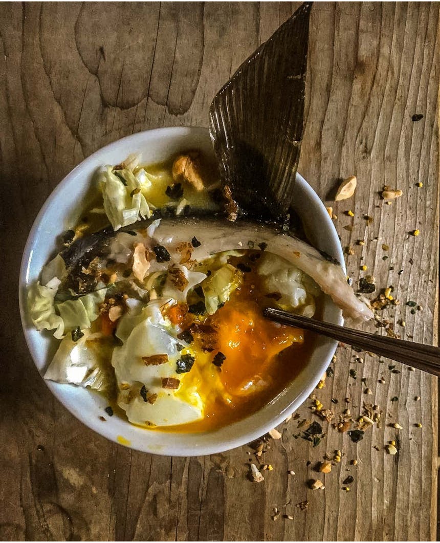 a bowl of fish, egg and cabbage