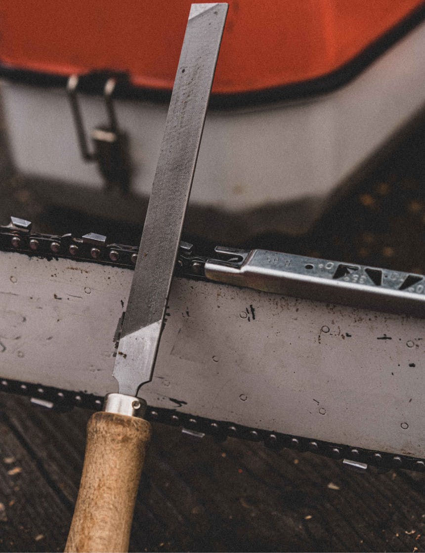 metal tool lying on a chainsaw blade