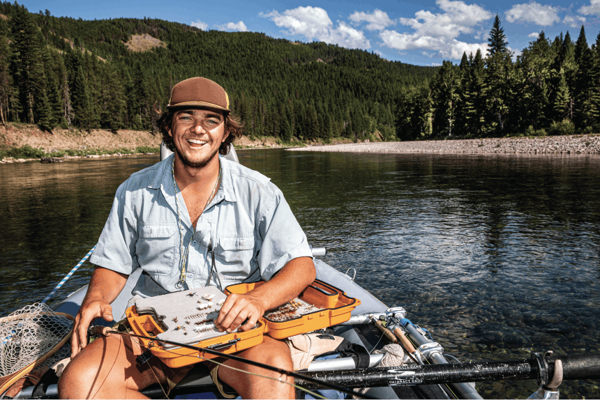 Adult male on a boat in wilderness setting.