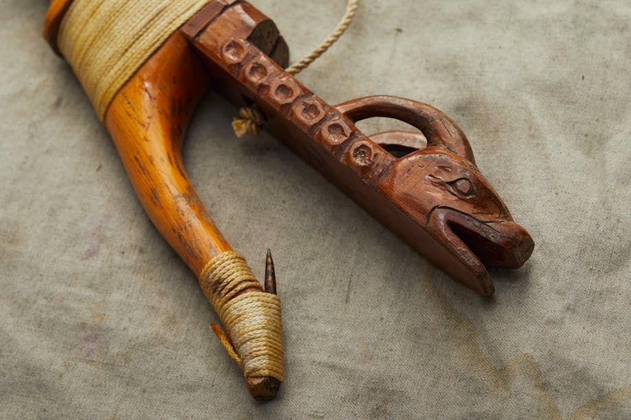 A wooden halibut hook, hand-crafted by Tlingit Master carver Jon Rowan of Klawock, Alaska.