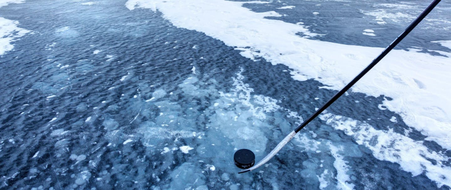 Ice hockey puck on frozen lake