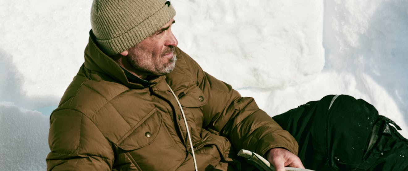 Male wearing down jacket in an Arctic landscape