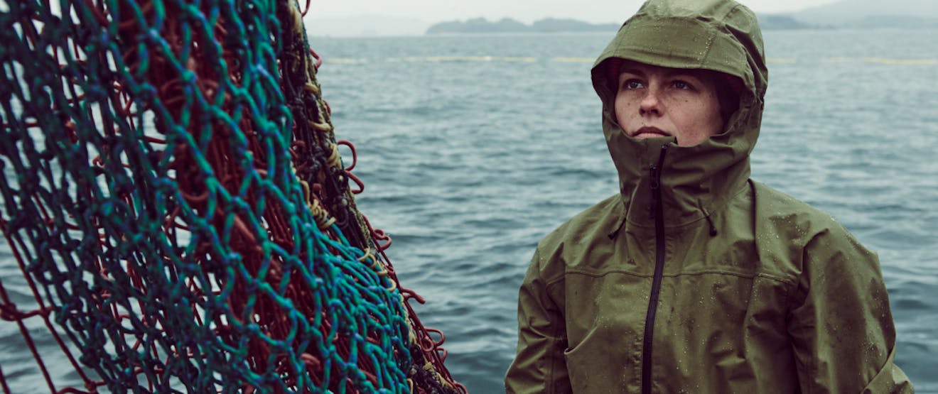 Woman wearing Filson rain jacket on a commercial fishing vessel