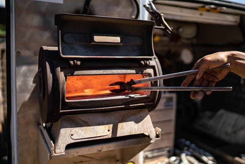 hot horseshoe being pulled from the forge