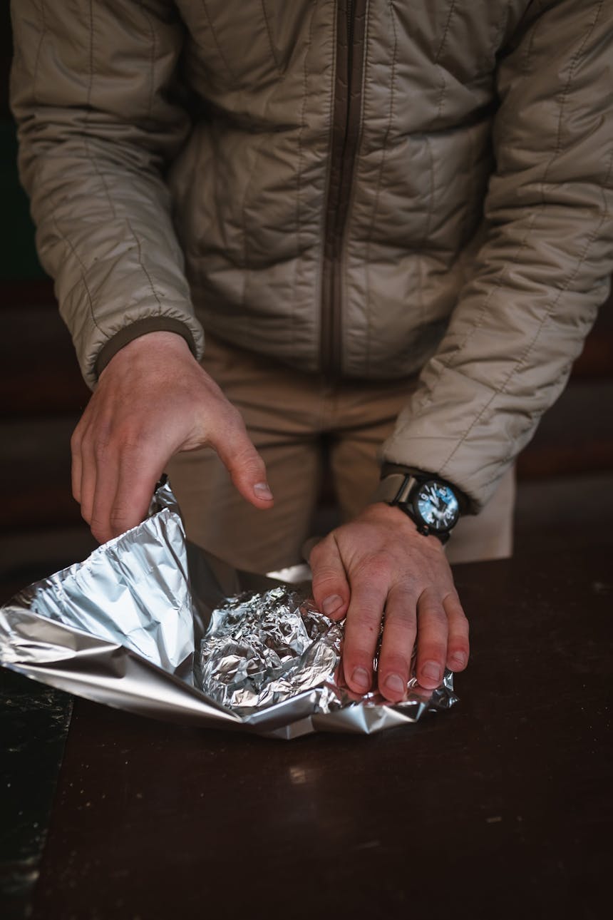 tightly wrapping tin foil meal