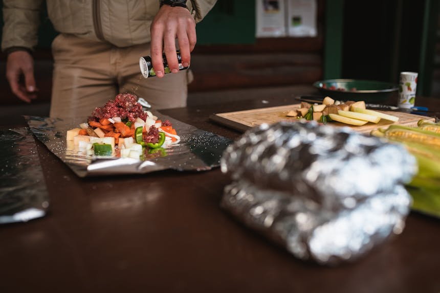 man seasoning prepared ingredients