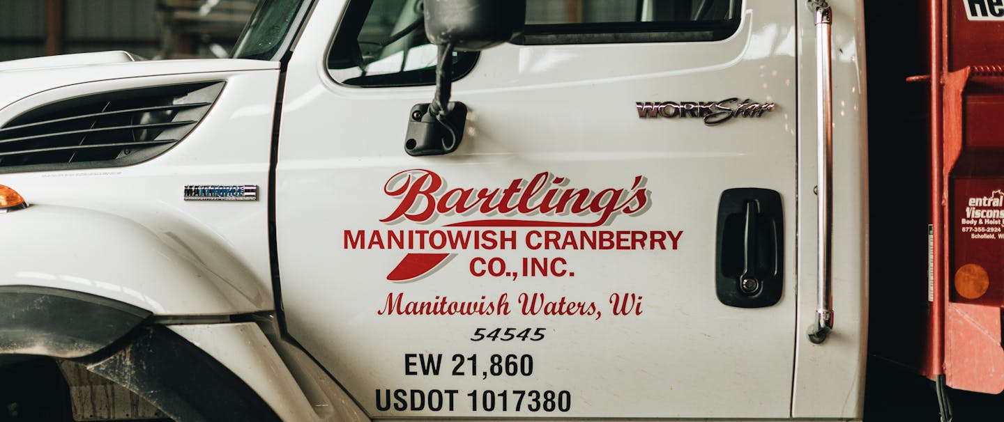 large white mac truck with bartlings manitowish cranberry co. inc. on door