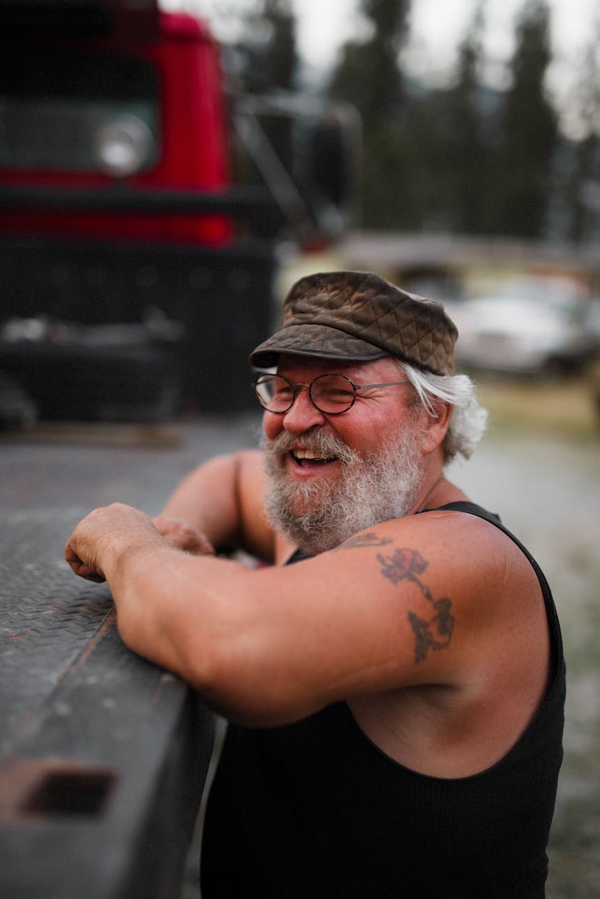 man smiling with arms on truck bed