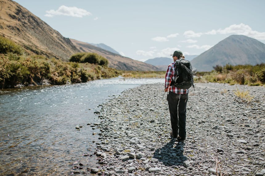 Jack walking along the river bank, looking for trout 