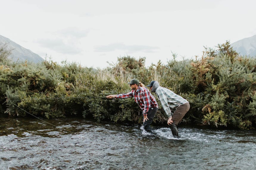 two men standing mid-stream 