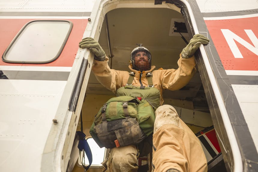 Smokejumper jumping out of plane
