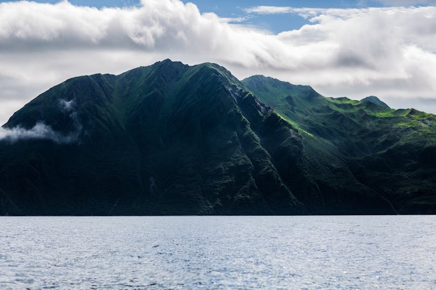 Kodiak coastline with tall green mountains and body of water