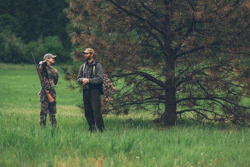 erin on a turkey hunt in grass field with camouflage on