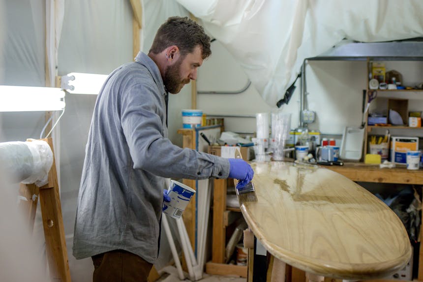 matthew painting a paddleboard