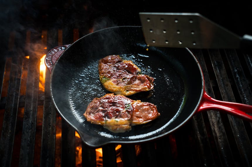 cooking breasts in red cast iron skillet